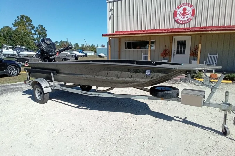 Slide: The Image of 2020 War Eagle 750 Gladiator boat on trailer outside a building. - 4