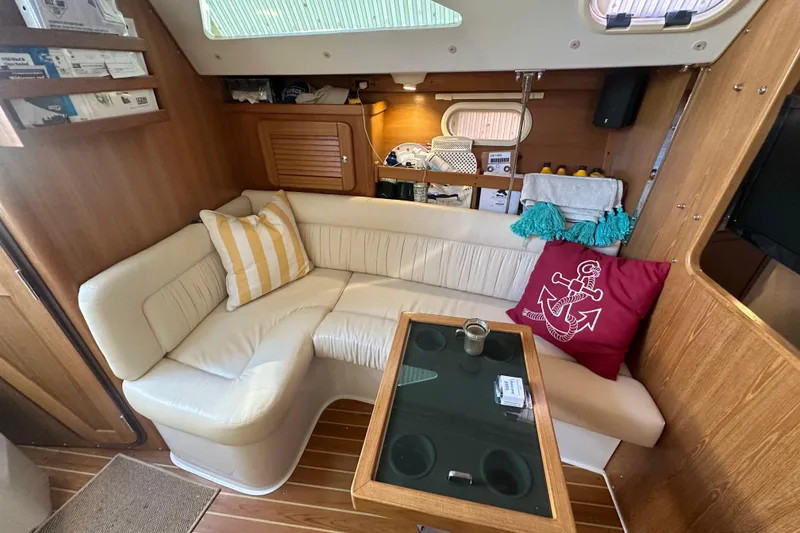 Slide: The Image of Interior of a 2005 Catalina 310 sailboat with cozy seating and nautical decor. - 14