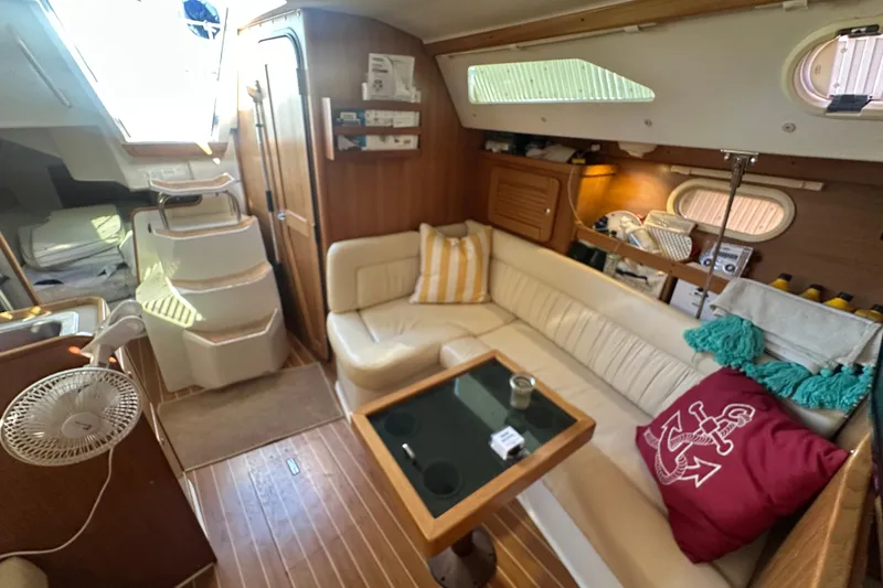 Slide: The Image of Interior of a 2005 Catalina 310 sailboat with cozy seating and nautical decor. - 25