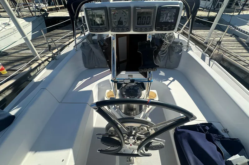 Slide: The Image of Cockpit of 2005 Catalina 310 sailboat with navigation instruments and steering wheel. - 7