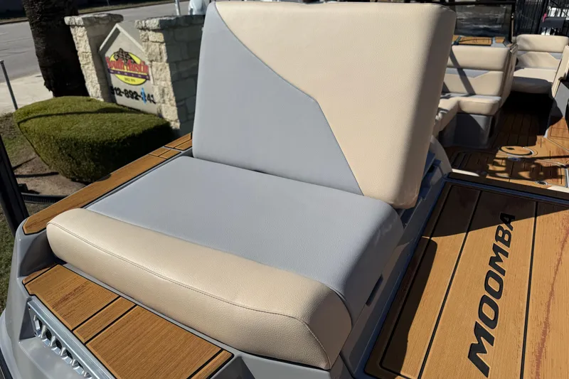 Slide: The Image of 2026 Moomba Mojo boat seat with beige and gray upholstery on teak deck. - 12