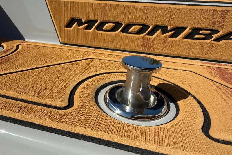 Slide: The Image of 2026 Moomba Mojo boat deck with chrome cleat and textured surface. - 13