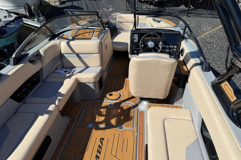 Slide: The Image of 2026 Moomba Mojo boat interior with beige seating and modern dashboard. - 18