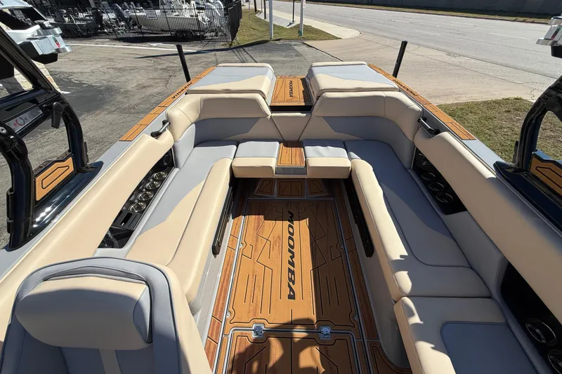 Slide: The Image of 2026 Moomba Mojo boat interior with beige seating and wood accents. - 19