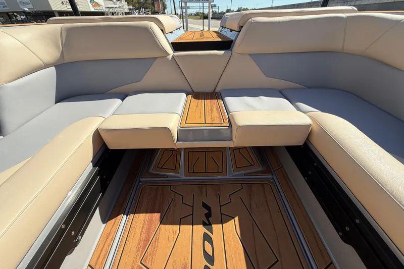 Slide: The Image of 2026 Moomba Mojo boat interior with beige seating and wooden flooring. - 22