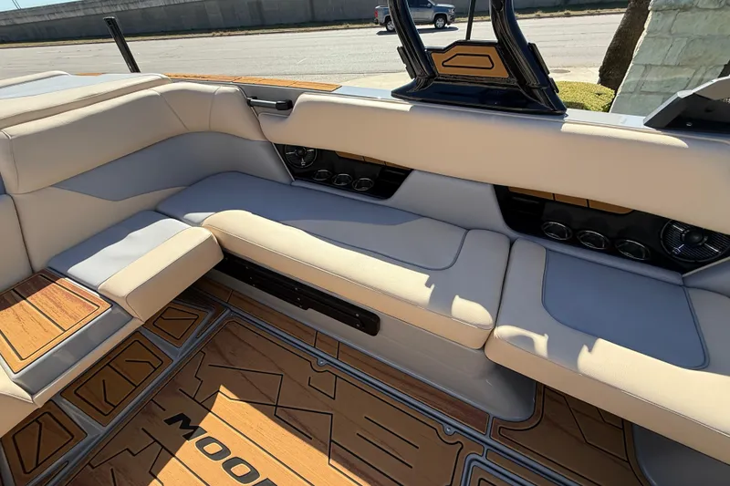 Slide: The Image of 2026 Moomba Mojo boat interior with beige seating and wood accents. - 23