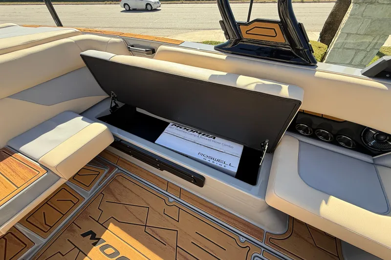 Slide: The Image of 2026 Moomba Mojo boat interior with open storage compartment and Roswell Marine accessories. - 24