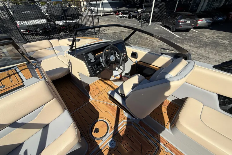 Slide: The Image of 2026 Moomba Mojo boat interior with beige seating and wood-style flooring. - 27