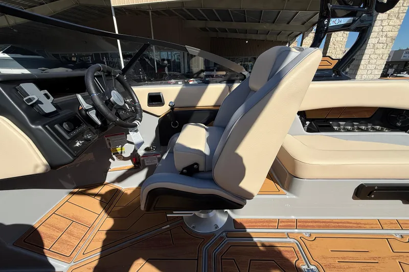 Slide: The Image of 2026 Moomba Mojo boat interior with beige seating and modern dashboard design. - 28