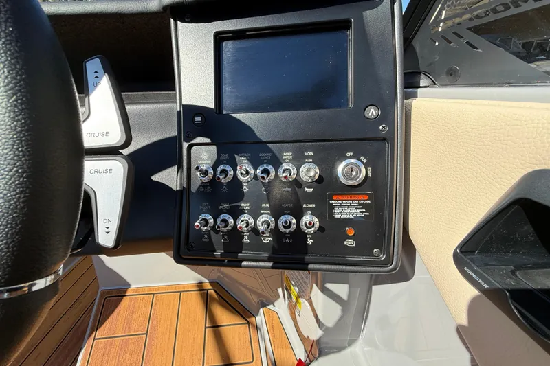 Slide: The Image of 2026 Moomba Mojo boat dashboard with control panel and switches. - 30