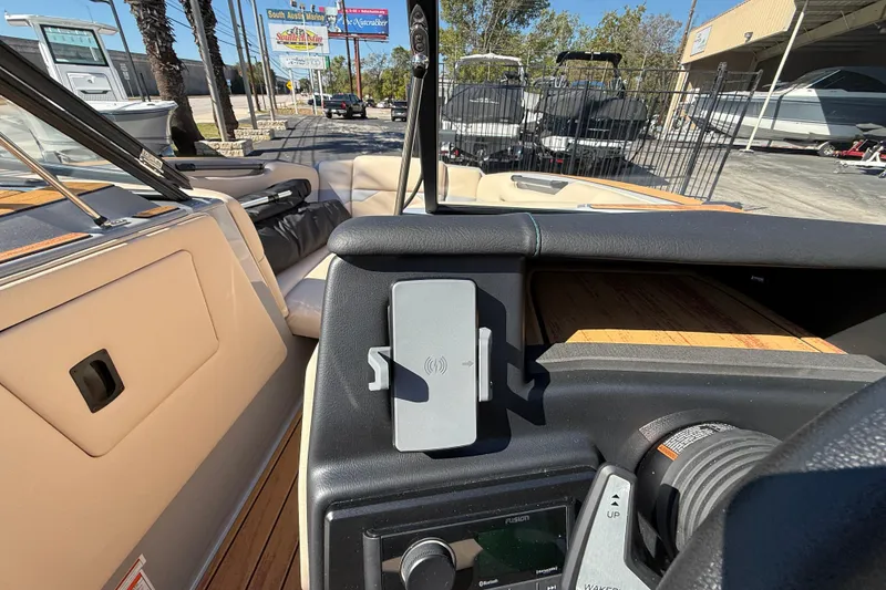 Slide: The Image of 2026 Moomba Mojo boat interior with dashboard and seating, showcasing modern design and features. - 33