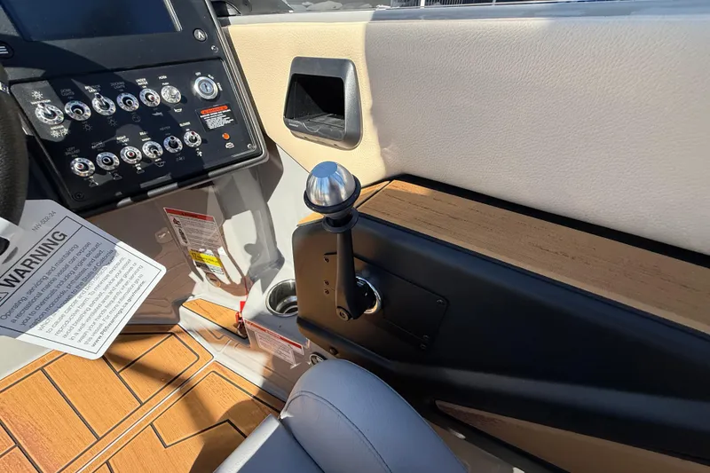 Slide: The Image of 2026 Moomba Mojo boat dashboard with control panel and gear lever. - 36