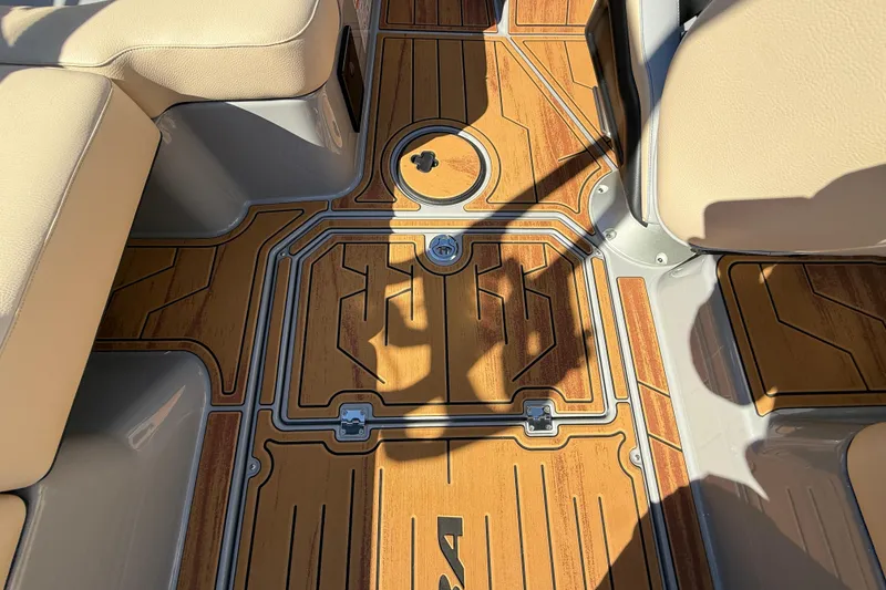 Slide: The Image of 2026 Moomba Mojo boat interior with stylish wood-patterned flooring and beige seating. - 38