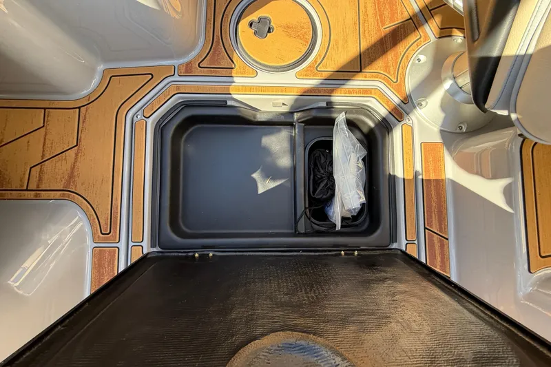 Slide: The Image of 2026 Moomba Mojo boat interior storage compartment with wood-patterned flooring. - 39