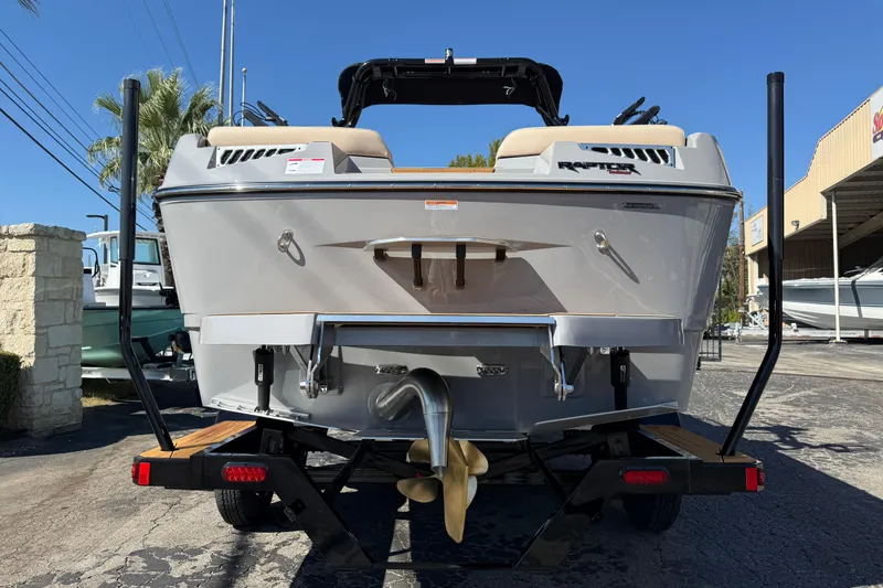 Slide: The Image of 2026 Moomba Mojo boat on trailer, rear view, showcasing propeller and Raptor engine. - 6