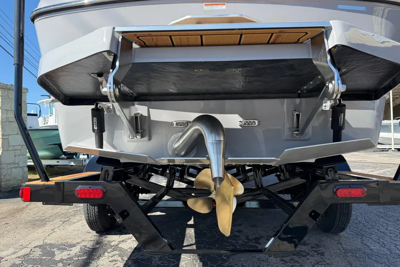 Slide: The Image of Rear view of 2026 Moomba Mojo boat on trailer, showcasing propeller and exhaust system. - 7