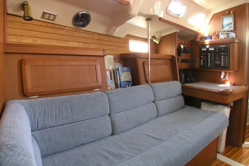 Slide: The Image of Interior of 1996 Hunter 37.5 Legend sailboat with blue sofa and navigation station. - 5