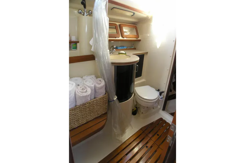 Slide: The Image of 1996 Hunter 37.5 Legend yacht bathroom with shower, sink, and toilet. - 7