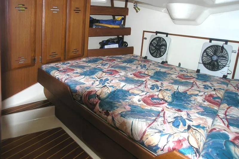 Slide: The Image of Cozy cabin interior of 1996 Hunter 37.5 Legend sailboat with floral bedding and fans. - 8