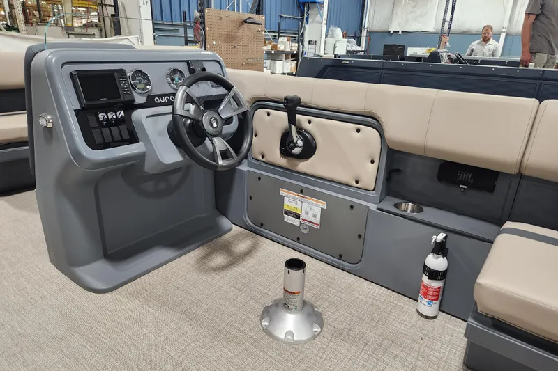 Slide: The Image of 2026 Avalon Aura Quad Lounge boat interior with steering console and seating. - 10