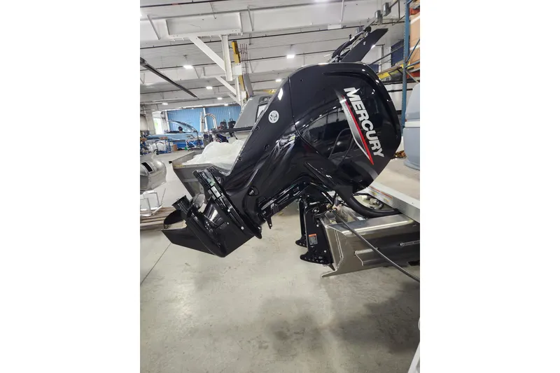 Slide: The Image of Outboard motor on 2026 Avalon Aura Quad Lounge boat in a factory setting. - 11
