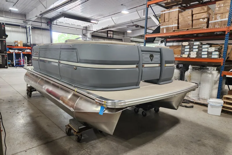 Slide: The Image of 2026 Avalon Aura Quad Lounge pontoon boat in a warehouse setting. - 13