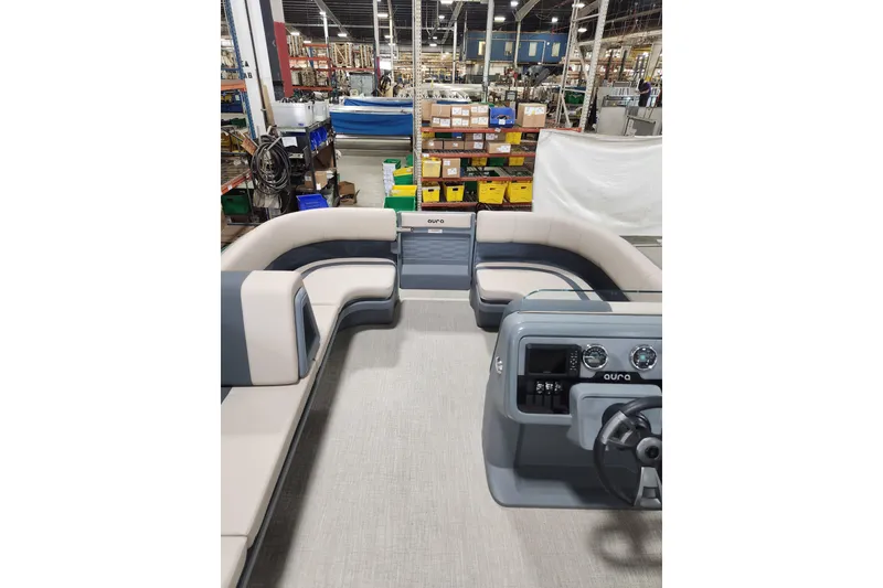 Slide: The Image of 2026 Avalon Aura Quad Lounge boat interior with spacious seating in a factory setting. - 8