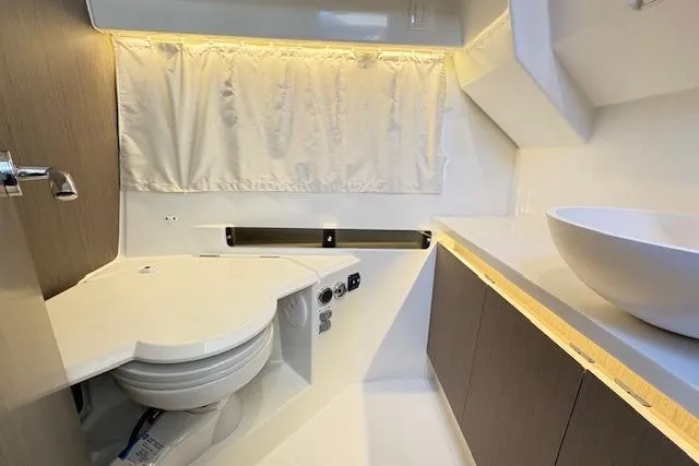 Slide: The Image of Interior of 2024 Jeanneau NC 895 Series 2, featuring a cozy dining area with marina view. - 10