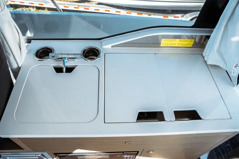 Slide: The Image of Captain's chair inside 2024 Jeanneau NC 895 Series 2 boat, with marina view. - 17