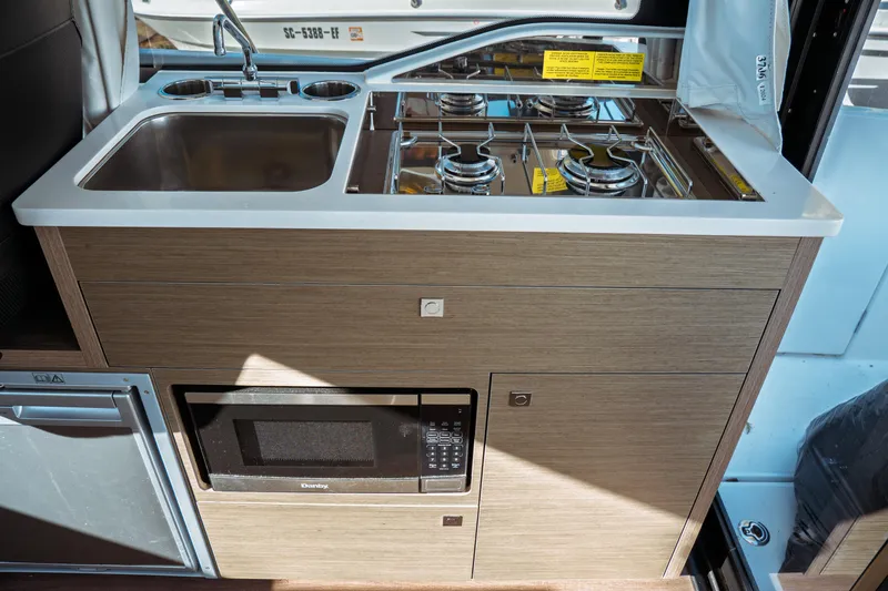 Slide: The Image of 2024 Jeanneau NC 895 Series 2 helm with Garmin navigation system and steering wheel. - 18