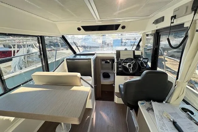 Slide: The Image of 2024 Jeanneau NC 895 Series 2 boat docked in a marina. - 2