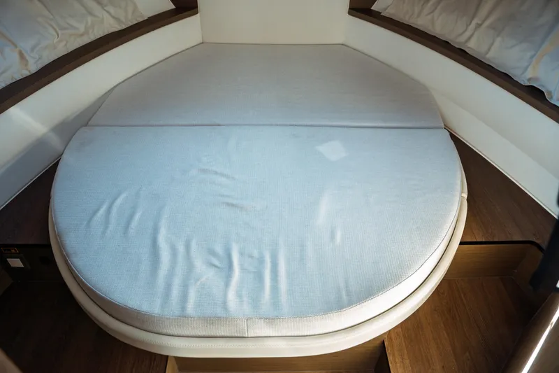 Slide: The Image of 2024 Jeanneau NC 895 Series 2 interior storage compartment with wooden finish. - 31