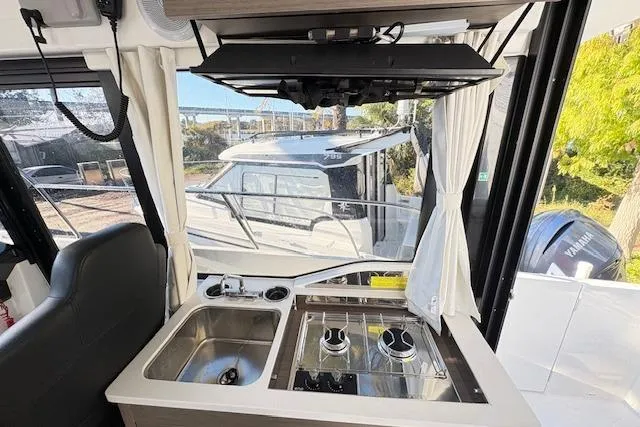 Slide: The Image of 2024 Jeanneau NC 895 Series 2 boat deck with Yamaha engines and seating area. - 6