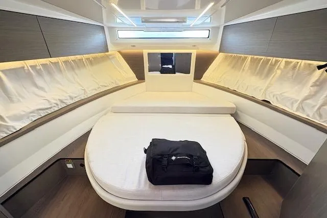 Slide: The Image of Interior of 2024 Jeanneau NC 895 Series 2 boat with helm, seating, and kitchenette. - 8