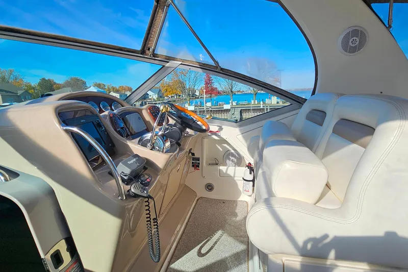 Slide: The Image of Interior cockpit of 2004 Sea Ray 320 Sundancer with dual seats and control panel. - 10