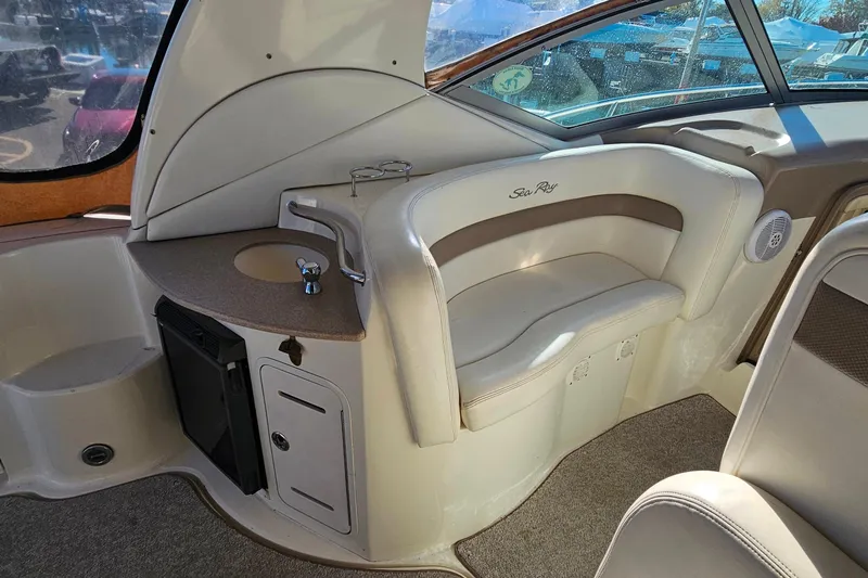 Slide: The Image of 2004 Sea Ray 320 Sundancer interior with seating, sink, and storage. - 16