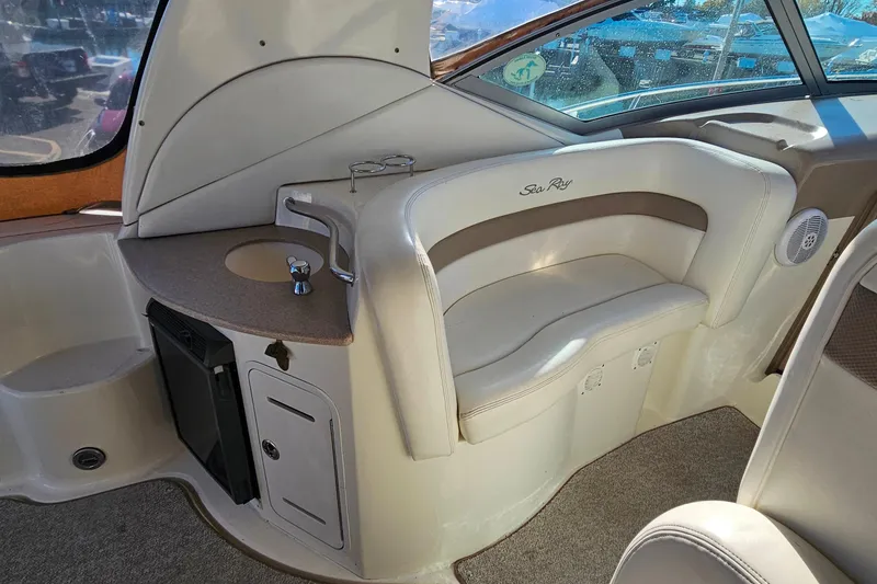 Slide: The Image of 2004 Sea Ray 320 Sundancer interior seating with logo and speaker. - 17