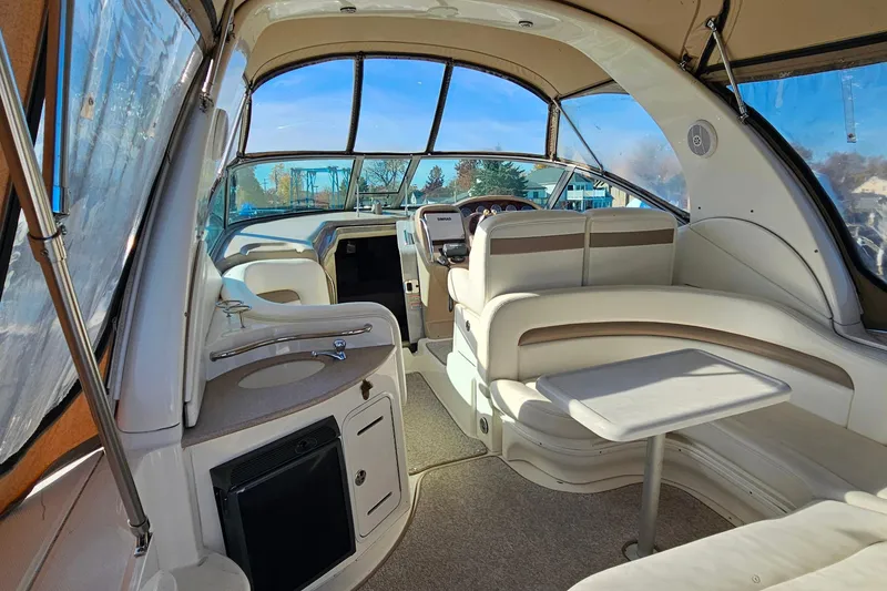 Slide: The Image of Interior of 2004 Sea Ray 320 Sundancer boat with seating and helm. - 2
