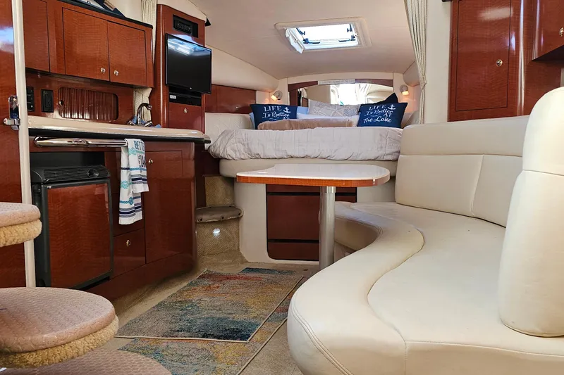 Slide: The Image of Interior of 2004 Sea Ray 320 Sundancer yacht with cozy seating and modern amenities. - 20