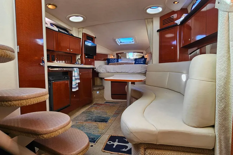 Slide: The Image of Luxurious interior of 2004 Sea Ray 320 Sundancer with kitchenette and cozy sleeping area. - 21