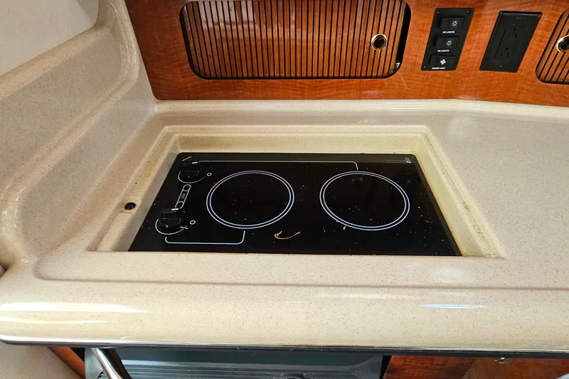 Slide: The Image of Luxurious interior of 2004 Sea Ray 320 Sundancer with curved seating and elegant table. - 24