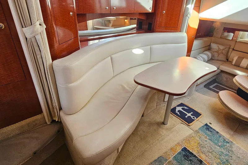 Slide: The Image of Luxurious 2004 Sea Ray 320 Sundancer cabin with cozy bed and elegant wood finishes. - 25