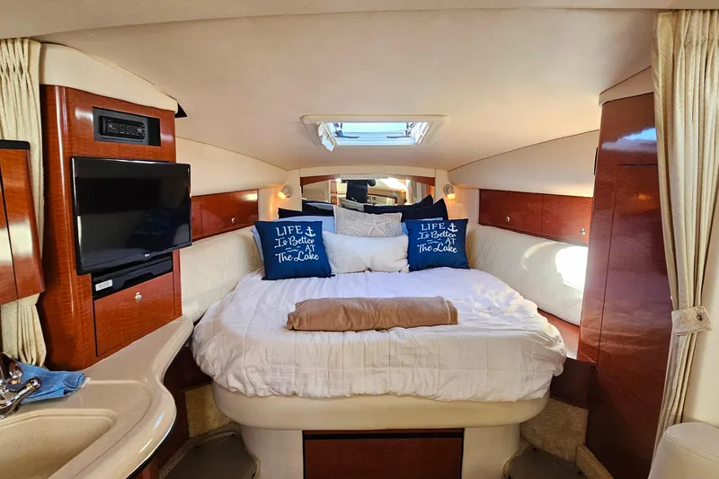 Slide: The Image of Luxurious interior of 2004 Sea Ray 320 Sundancer with cozy bed and elegant wood finishes. - 26
