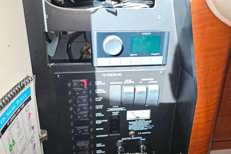 Slide: The Image of Interior of 2004 Sea Ray 320 Sundancer with TV, cabinets, and kitchenette. - 29