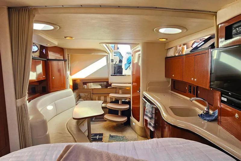 Slide: The Image of 2004 Sea Ray 320 Sundancer bathroom with sink, toilet, and storage cabinets. - 31