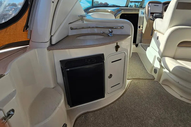 Slide: The Image of 2004 Sea Ray 320 Sundancer interior with beige seating and table. - 4