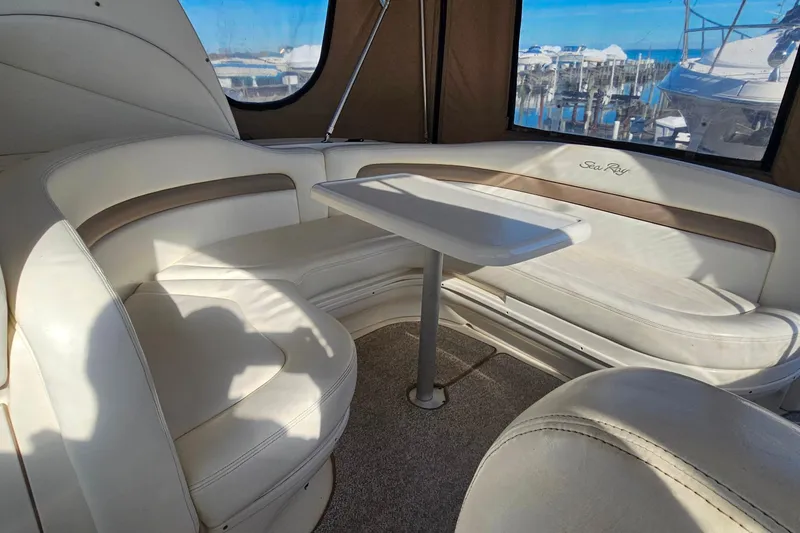 Slide: The Image of 2004 Sea Ray 320 Sundancer helm with modern navigation equipment and comfortable seating. - 6