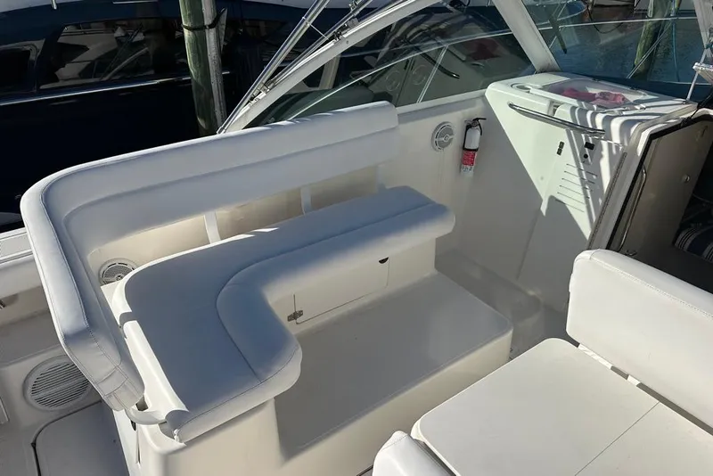 Slide: The Image of 2002 Tiara Yachts 2900 Coronet interior with white seating and storage compartments. - 14