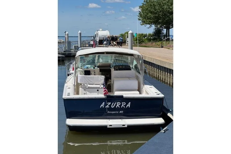 Slide: The Image of 2002 Tiara Yachts 2900 Coronet docked, rear view, sunny day, "AZURRA" name visible. - 5