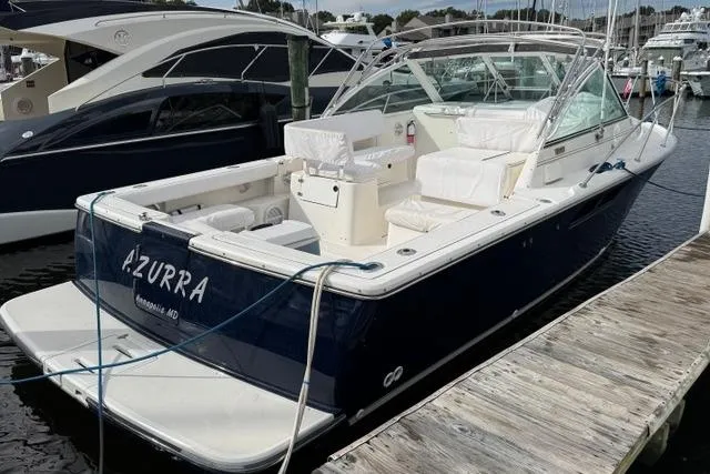 Slide: The Image of 2002 Tiara Yachts 2900 Coronet docked, featuring spacious seating and sleek design. - 8